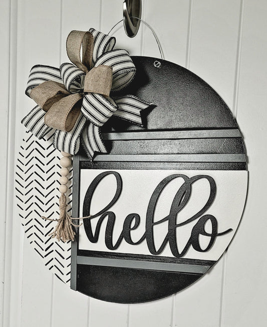 Handmade black and white round wooden "Hello" door sign featuring modern farmhouse design, striped and burlap bow, wood bead tassel, and chevron pattern – perfect for front door, porch, or entryway decor.
