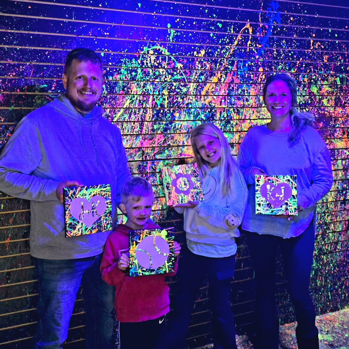 Family showing off their Splatter Paint masterpiece at Rachel's Crafty Corner in Statesville NC