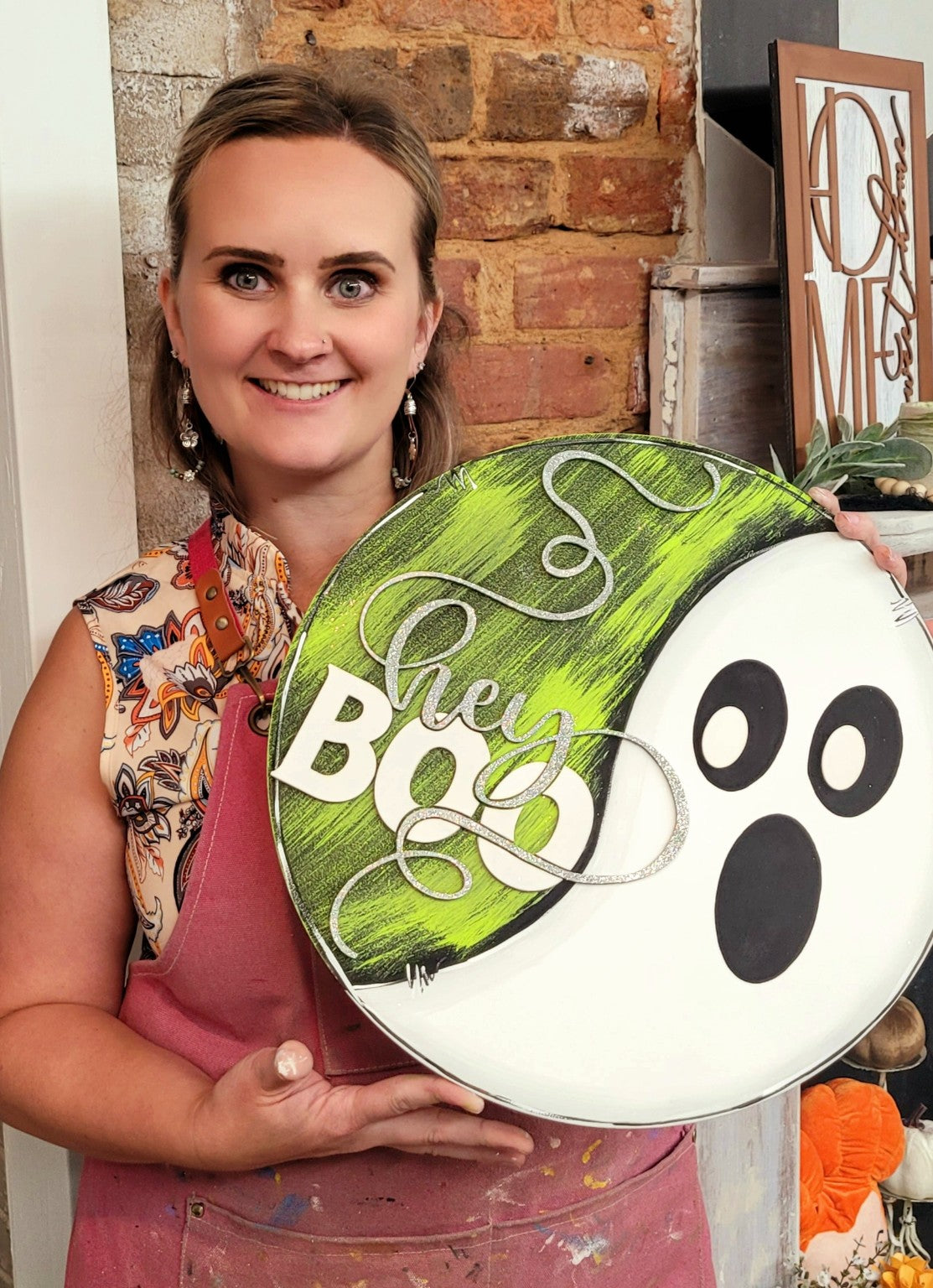 Rachel holding a Hey Boo Halloween ghost door hanger